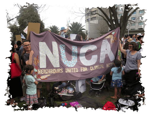 People holding NUCA flag at a climate rally
